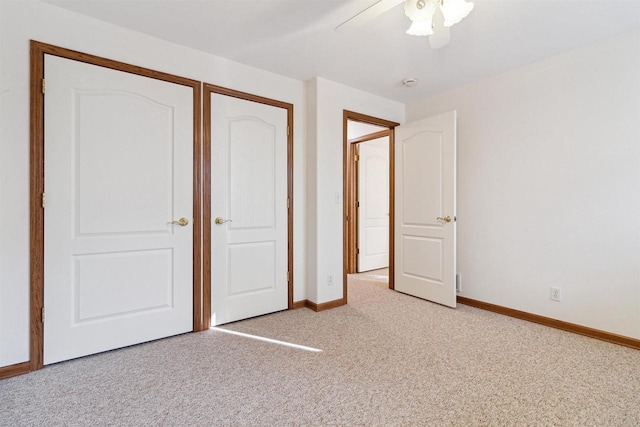 unfurnished bedroom with ceiling fan, light carpet, and a closet