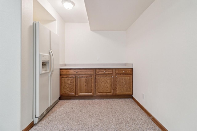 kitchen featuring white fridge with ice dispenser