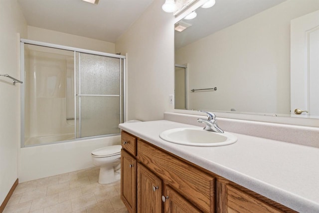 full bathroom with vanity, toilet, and shower / bath combination with glass door