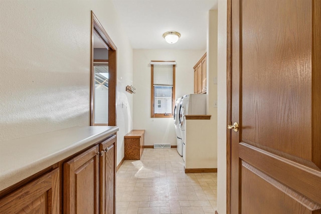 interior space featuring washer and dryer and cabinets