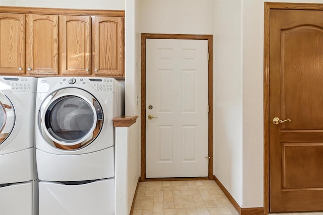 washroom with cabinets and separate washer and dryer