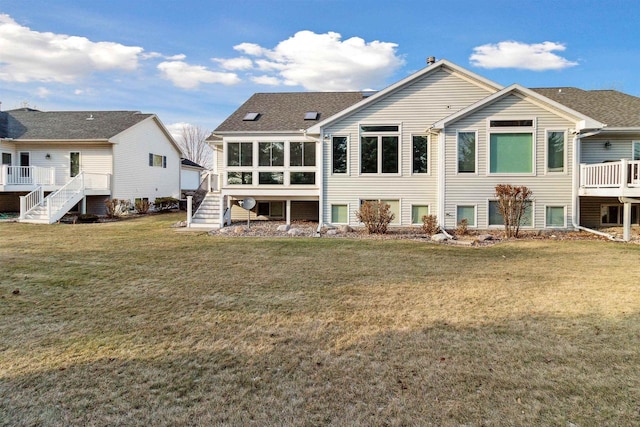 rear view of property featuring a lawn