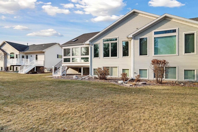 rear view of property with a sunroom and a yard