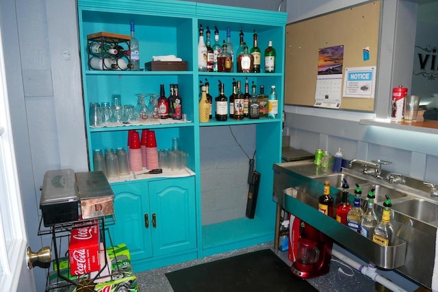 bar with blue cabinetry and backsplash