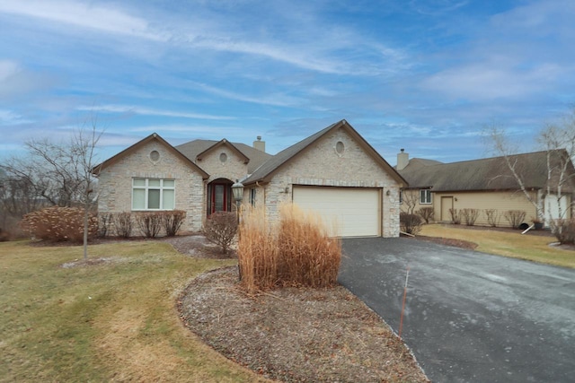 single story home featuring a front yard and a garage