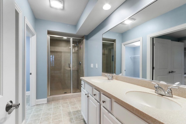 bathroom featuring vanity and a shower with door