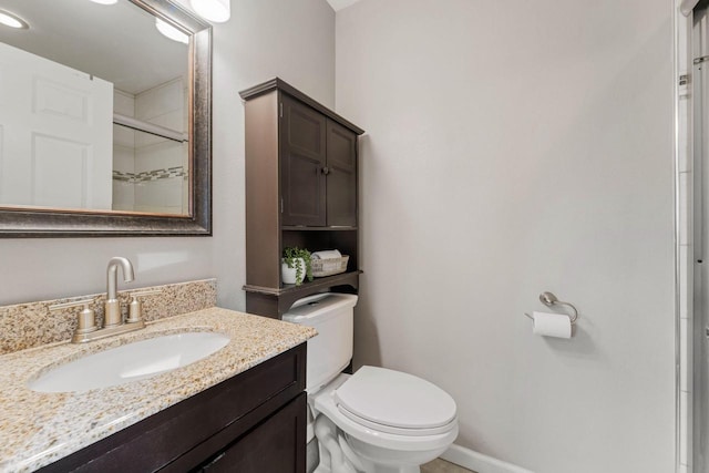 bathroom featuring walk in shower, vanity, and toilet