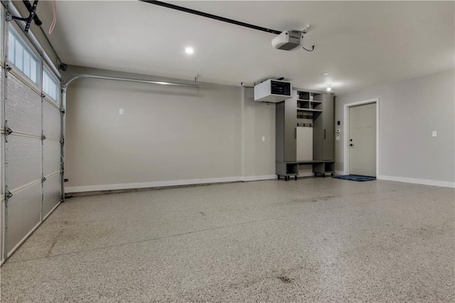 garage with a garage door opener and baseboards