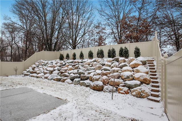 yard covered in snow featuring a fenced backyard