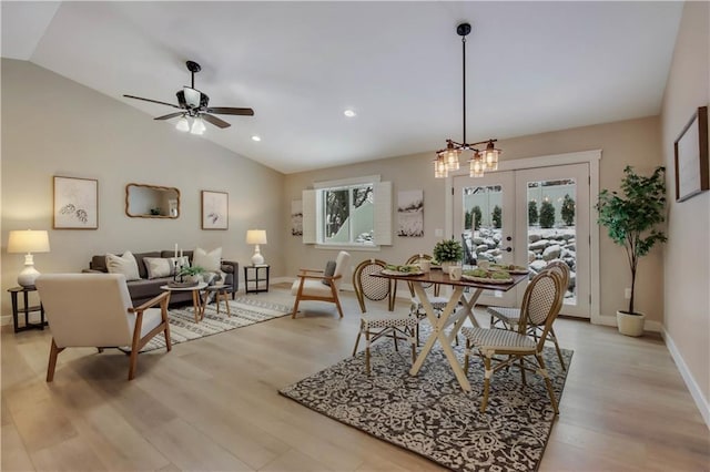 dining room featuring french doors, light hardwood / wood-style flooring, vaulted ceiling, and ceiling fan