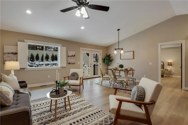 living area with light wood finished floors, recessed lighting, baseboards, and lofted ceiling