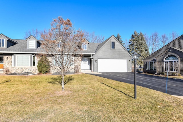 new england style home with a front yard and a garage