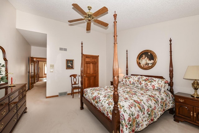 carpeted bedroom with a textured ceiling and ceiling fan