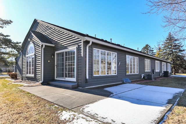 view of property exterior featuring central AC unit and a patio area