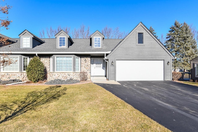 new england style home featuring a garage and a front yard