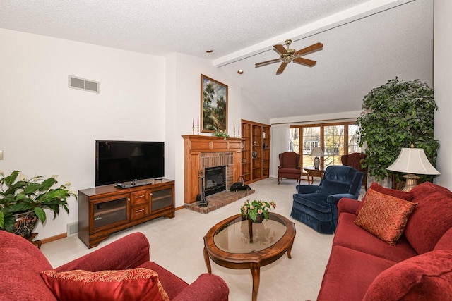 living room with light carpet, ceiling fan, vaulted ceiling with beams, a textured ceiling, and a fireplace