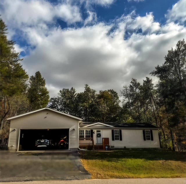 single story home with a front yard and a garage