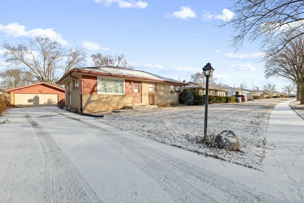 ranch-style home featuring an outbuilding and a garage