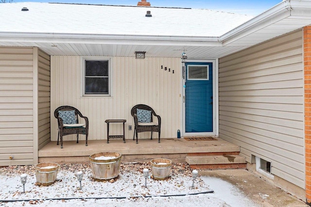 view of snow covered property entrance