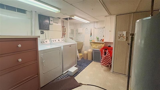 washroom with washer and dryer, electric panel, and sink