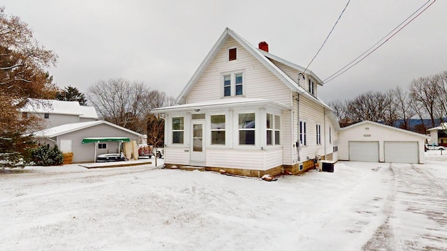 view of front of property with a garage and an outbuilding