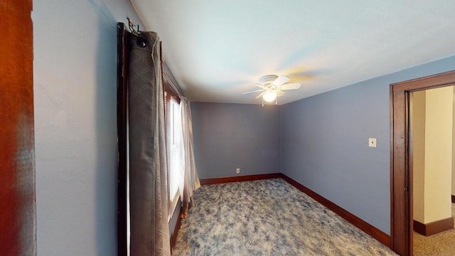 empty room with ceiling fan and carpet floors