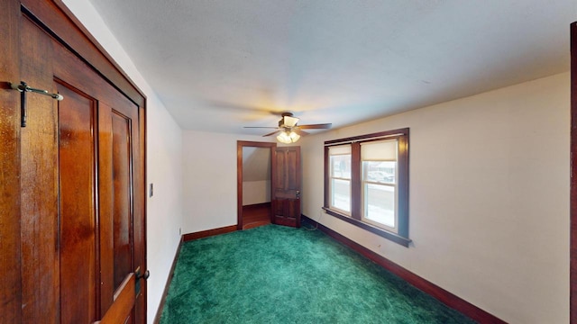 unfurnished bedroom with dark colored carpet and ceiling fan