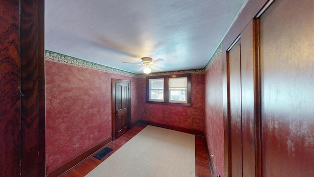 interior space with wood-type flooring and ceiling fan