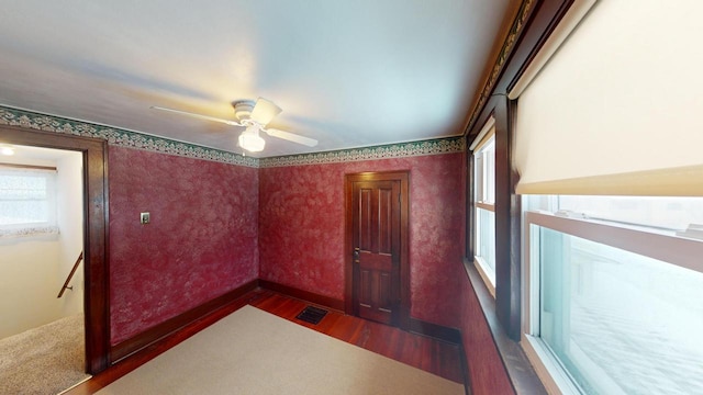 empty room featuring ceiling fan and dark hardwood / wood-style flooring