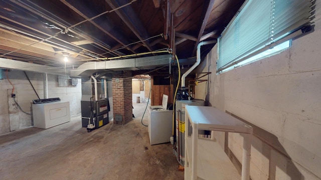 basement featuring washer / clothes dryer, heating unit, and water heater