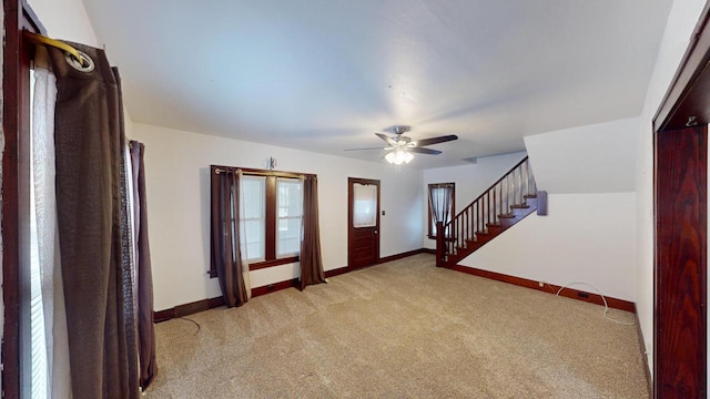 carpeted entrance foyer with ceiling fan