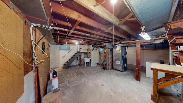 basement featuring refrigerator and heating unit