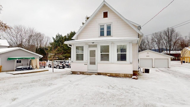 view of front of home with a garage and an outdoor structure