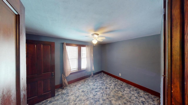 unfurnished bedroom with carpet flooring, ceiling fan, and a textured ceiling