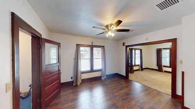 empty room with ceiling fan and dark hardwood / wood-style floors