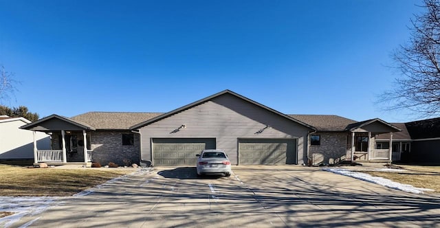 ranch-style home featuring a garage and covered porch