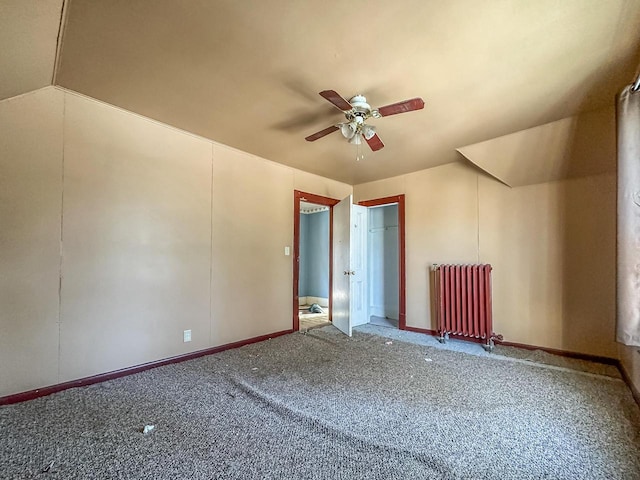 additional living space with carpet flooring, radiator heating unit, vaulted ceiling, and ceiling fan