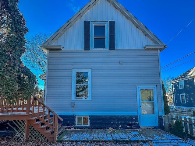 back of property featuring a wooden deck