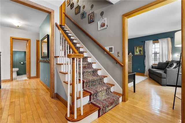 staircase with hardwood / wood-style flooring