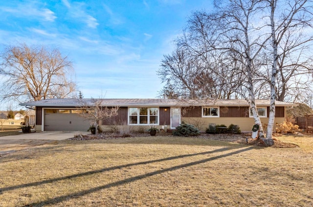 ranch-style home with a front yard and a garage