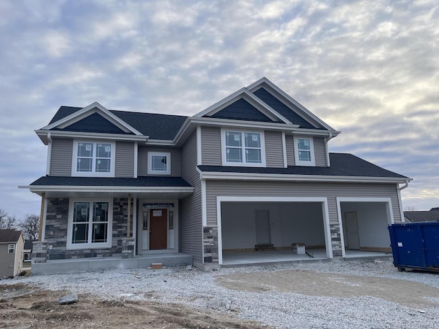 craftsman-style home with a porch and a garage