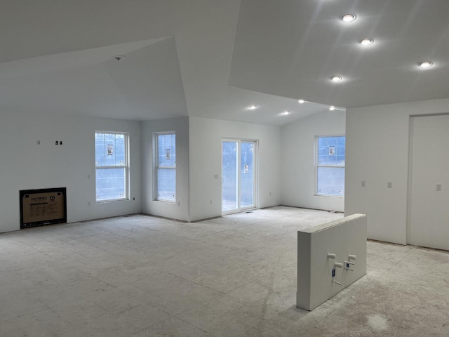 unfurnished room with vaulted ceiling