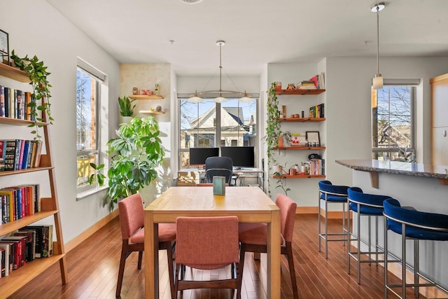 dining space featuring wood-type flooring