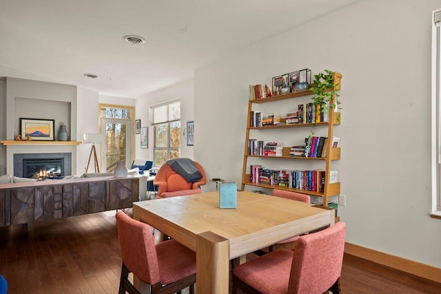 dining space with wood-type flooring