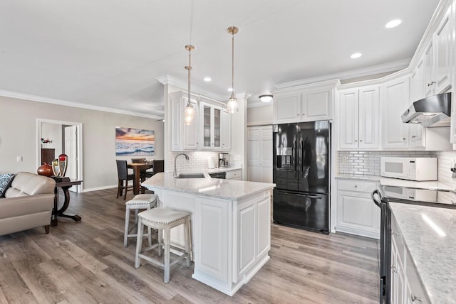 kitchen with black fridge, sink, hanging light fixtures, electric range, and white cabinetry