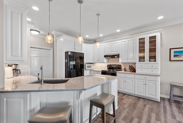 kitchen with white cabinetry, pendant lighting, and black appliances