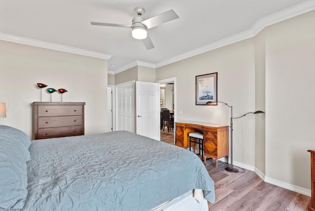 bedroom featuring ceiling fan, light hardwood / wood-style floors, and ornamental molding