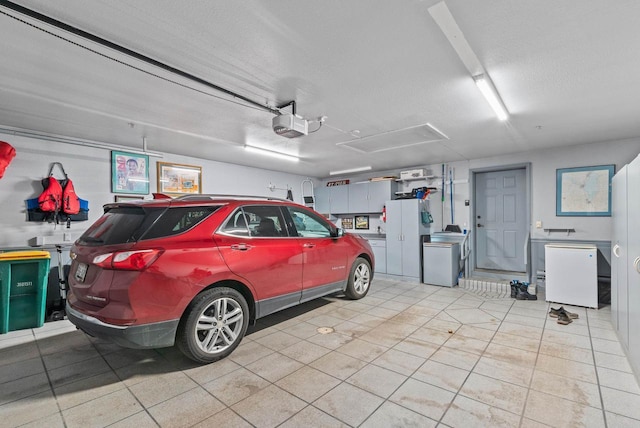 garage featuring washer / dryer, a garage door opener, and fridge