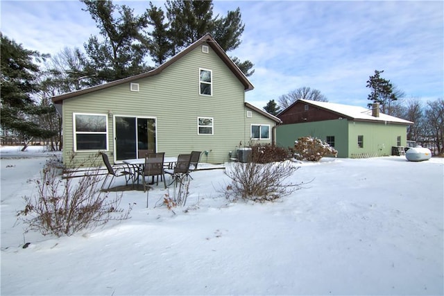 snow covered property featuring cooling unit