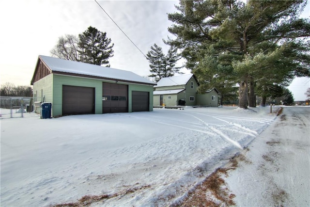 exterior space featuring a garage and an outbuilding